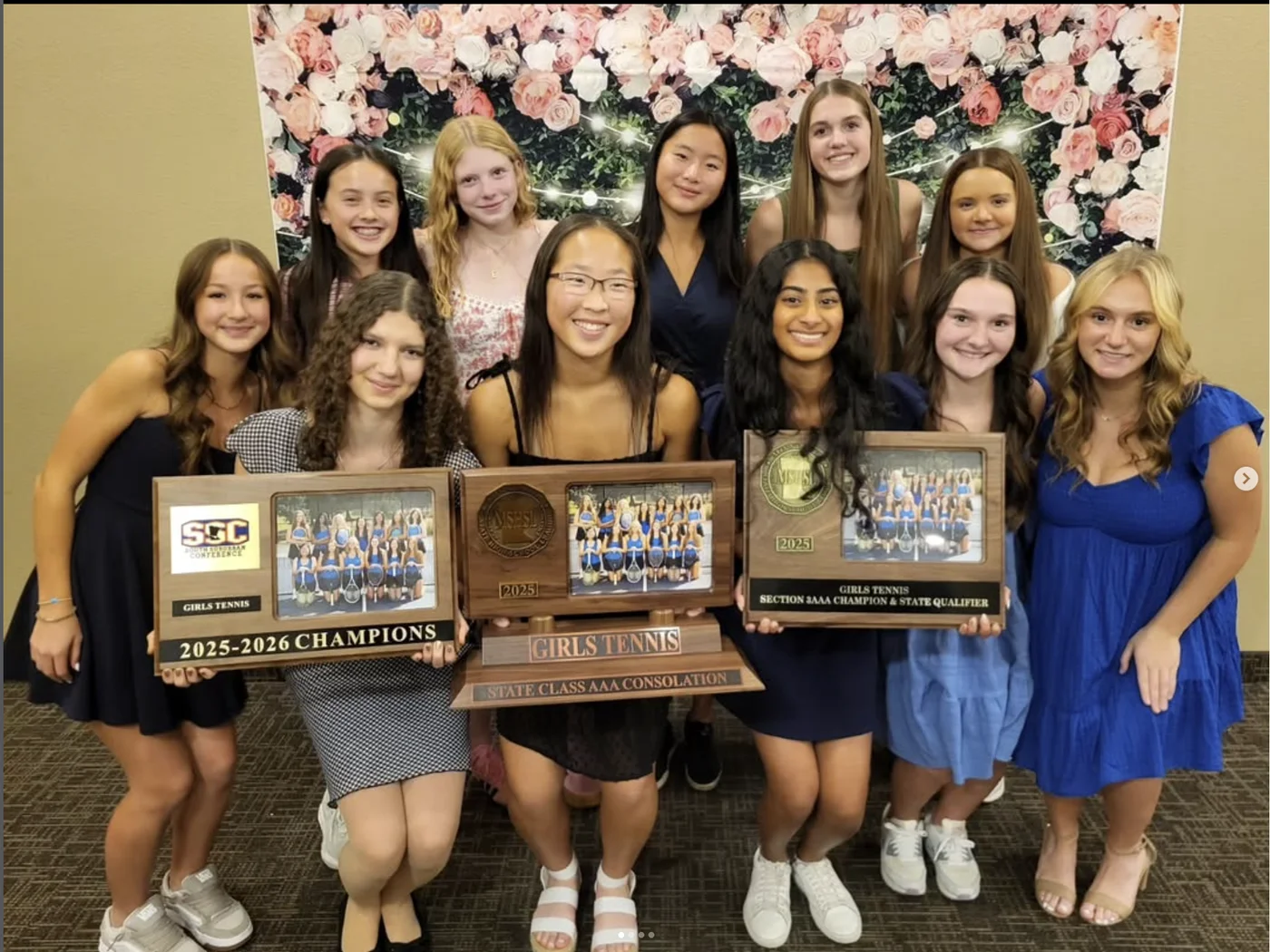 Eagan Girls Tennis players celebrating with their team awards at the 2025 banquet
